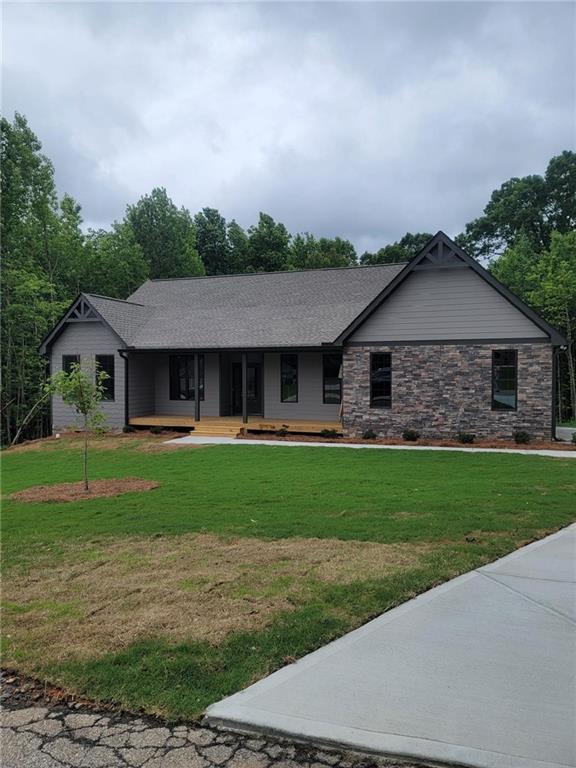 a front view of a house with a garden