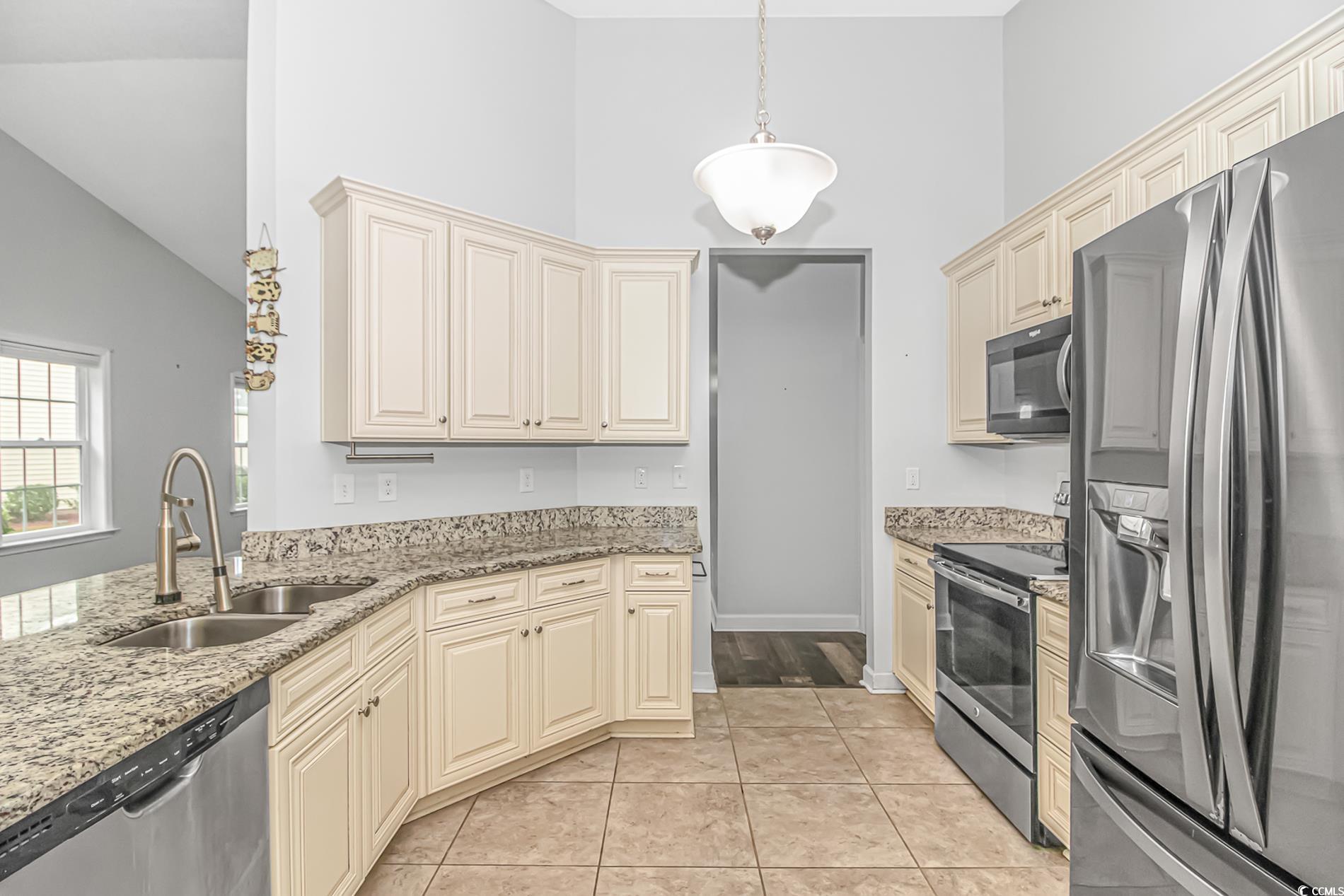 224 Rose Water Loop Myrtle Beach, SC 29588 - Photo 8 of 40 Kitchen with light stone counters, hanging light f