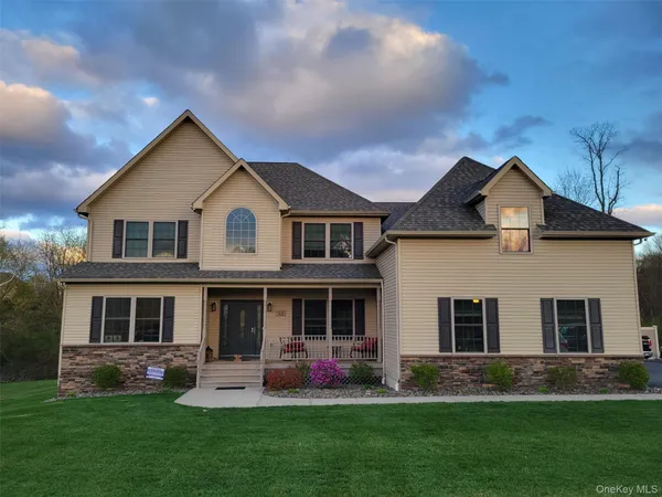 a front view of house with yard and green space