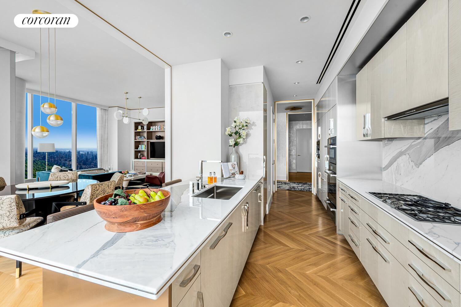 217 West 57th Street, Unit 84W Manhattan, NY 10019 - Photo 5 of 24 a large kitchen with a stove and a view of living room