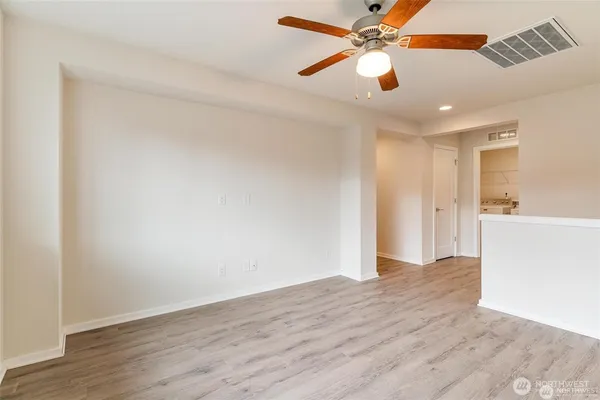 an empty room with closet and a bathroom