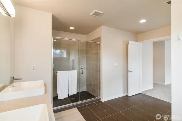 a bathroom with a double vanity sink and a mirror