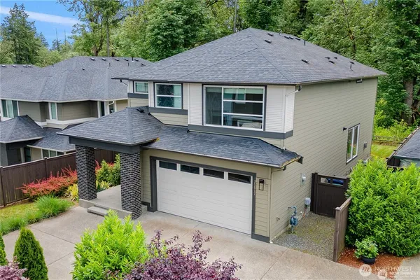 an aerial view of a houses with a swimming pool