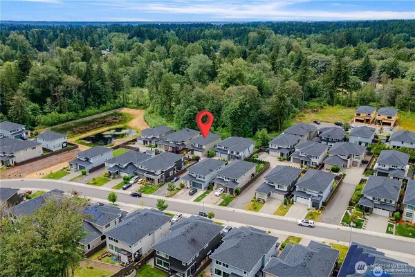 an aerial view of a houses with a yard