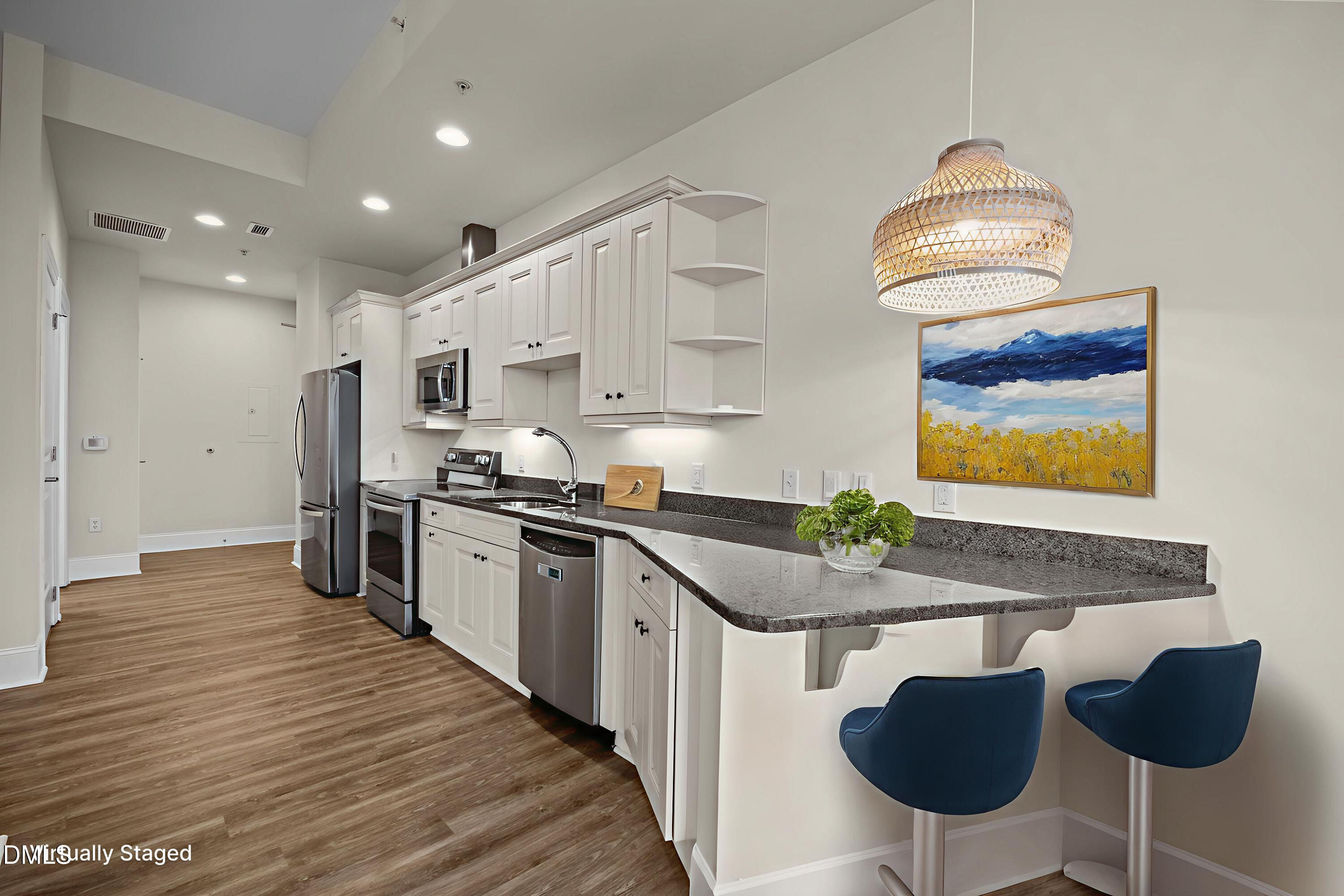 400 West North Street, Unit 814 Raleigh, NC 27603 - Photo 18 of 45 a kitchen with stainless steel appliances granite countertop a sink and a refrigerator