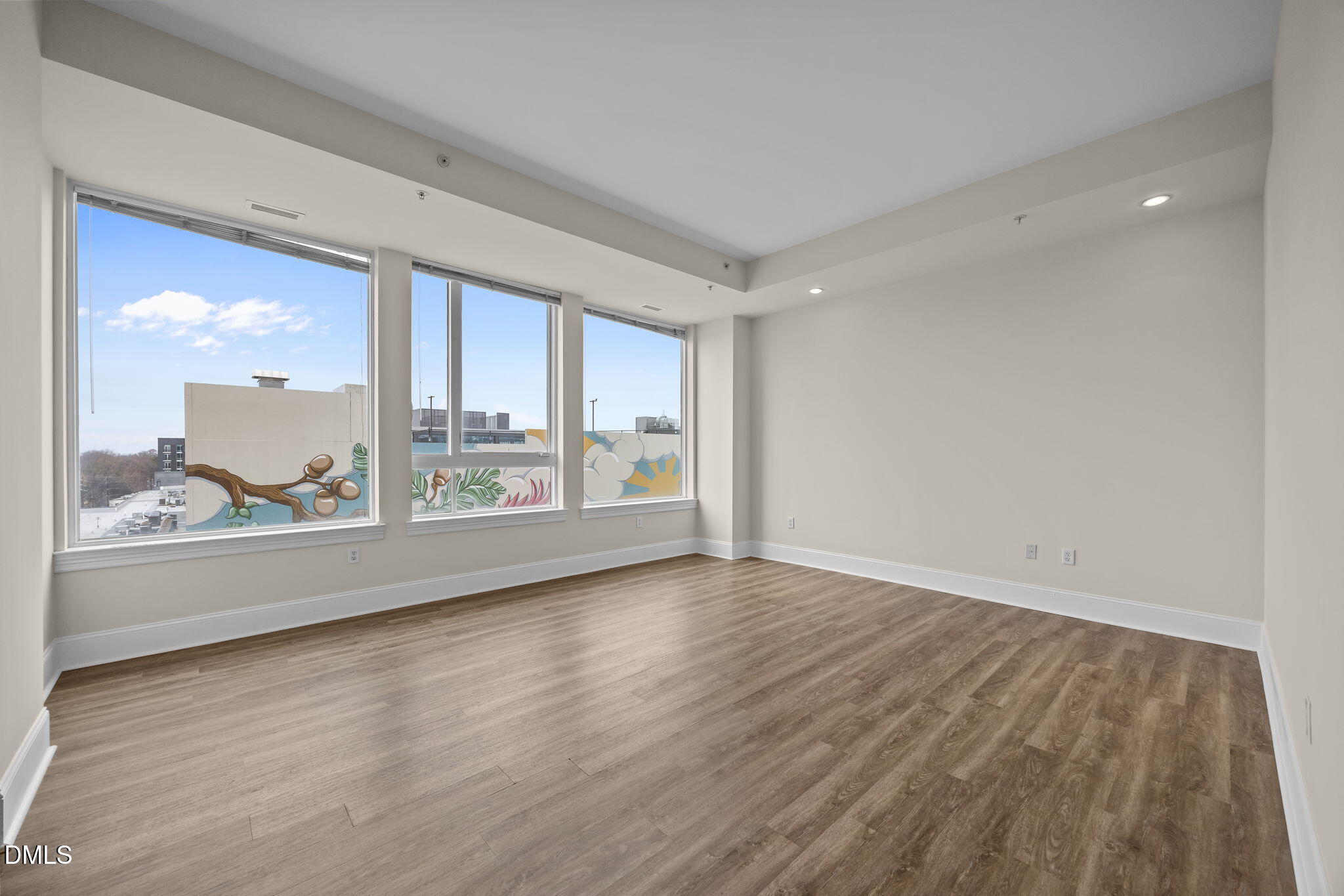 400 West North Street, Unit 814 Raleigh, NC 27603 - Photo 25 of 45 a view of an empty room with wooden floor and a window