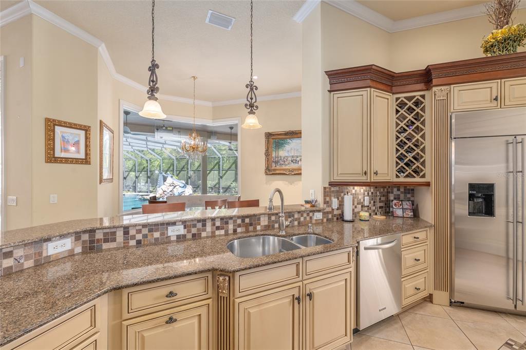 695 Southeast 47th Loop Ocala, FL 34480 - Photo 16 of 79 a kitchen with white cabinets a sink a window and stainless steel appliances