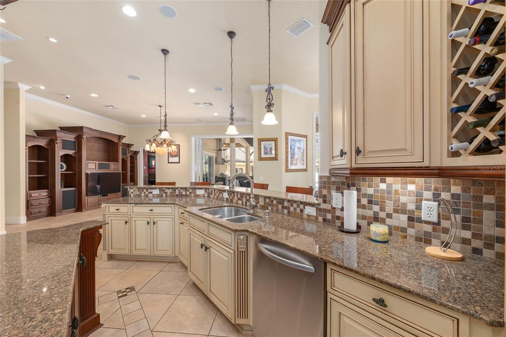 695 Southeast 47th Loop Ocala, FL 34480 - Photo 17 of 79 a kitchen with stainless steel appliances granite countertop a sink a stove and a wooden floor
