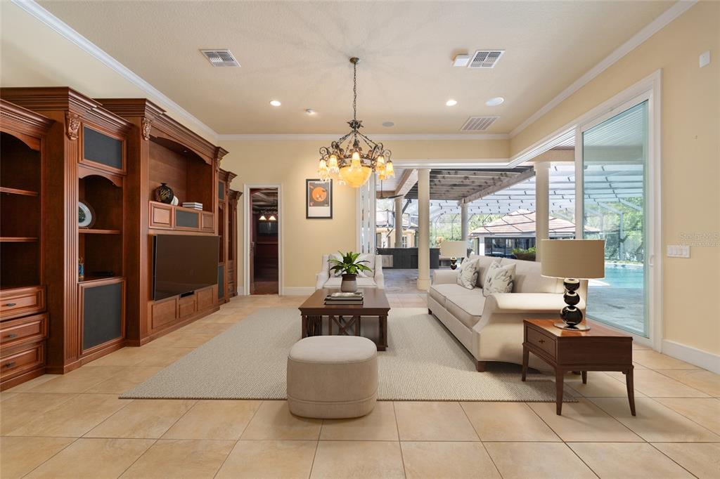 695 Southeast 47th Loop Ocala, FL 34480 - Photo 20 of 79 a living room with fireplace furniture and a chandelier