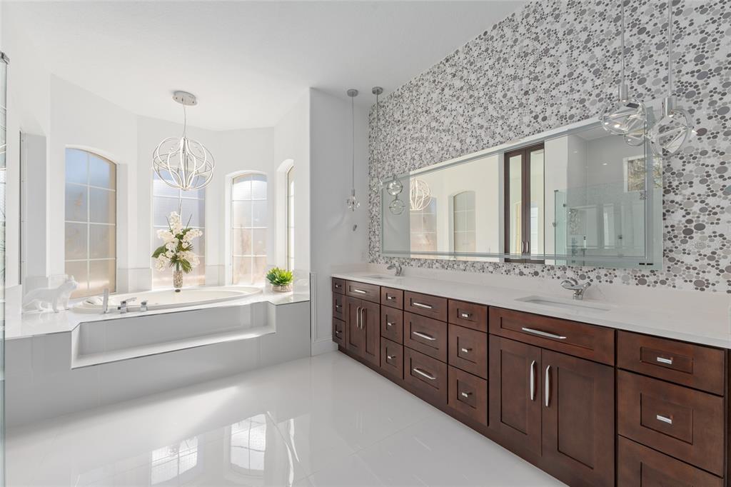 695 Southeast 47th Loop Ocala, FL 34480 - Photo 27 of 79 a spacious bathroom with a granite countertop tub sink and mirror