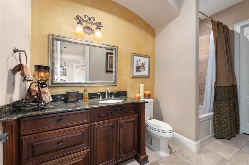 695 Southeast 47th Loop Ocala, FL 34480 - Photo 35 of 79 a bathroom with a granite countertop toilet sink and mirror