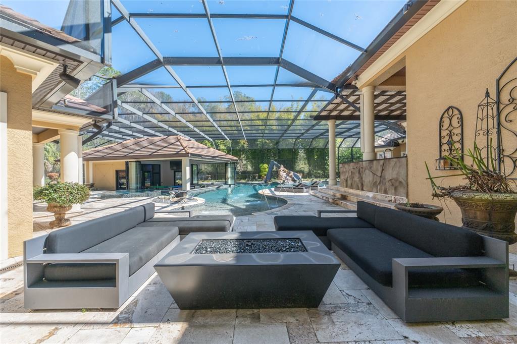 695 Southeast 47th Loop Ocala, FL 34480 - Photo 50 of 79 a living room with patio furniture and a fireplace