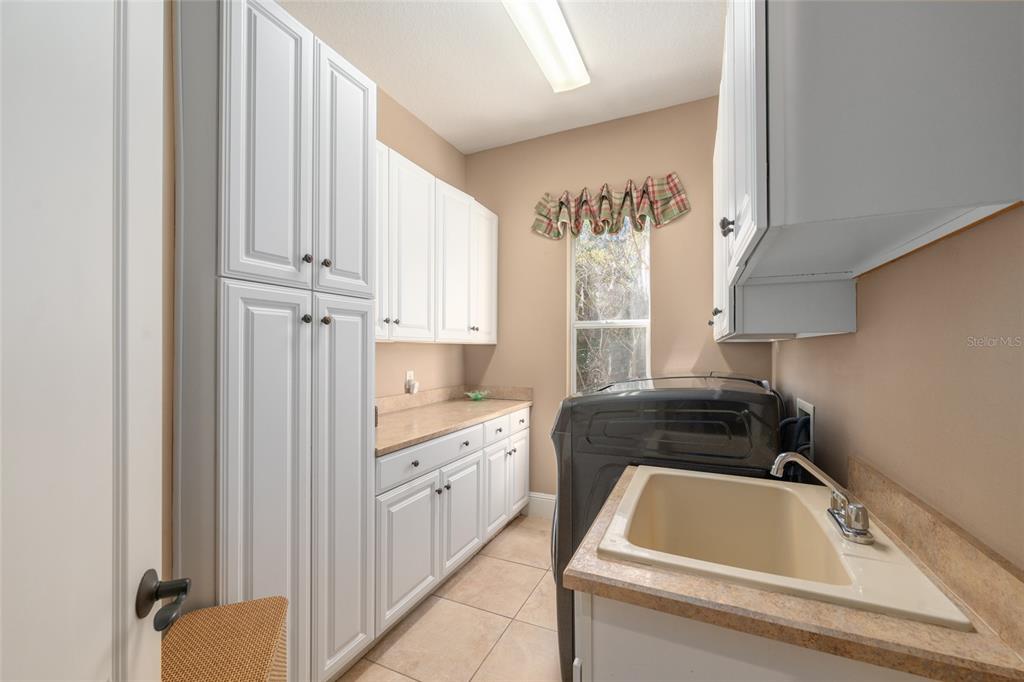 695 Southeast 47th Loop Ocala, FL 34480 - Photo 74 of 79 a kitchen with white cabinets a sink and a stove top oven