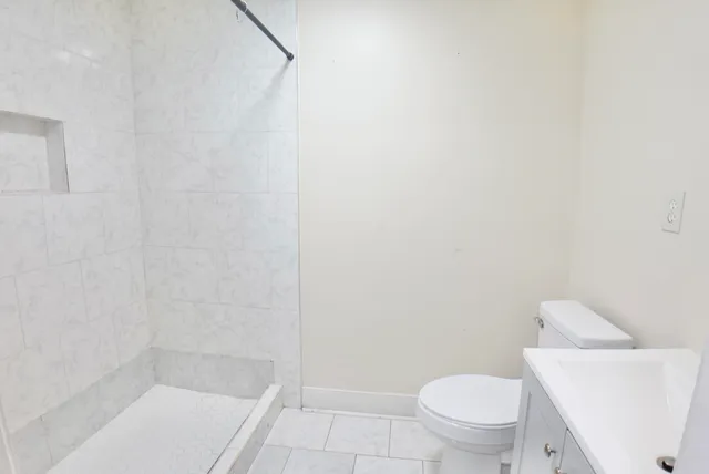 a white toilet sitting next to a bath tub