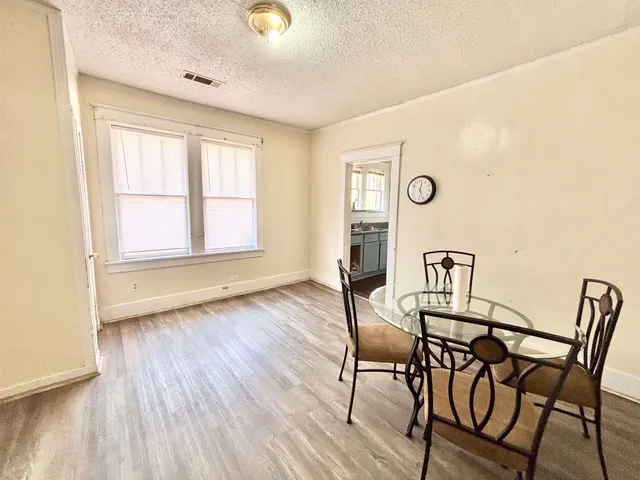 a view of a room with furniture and wooden floor