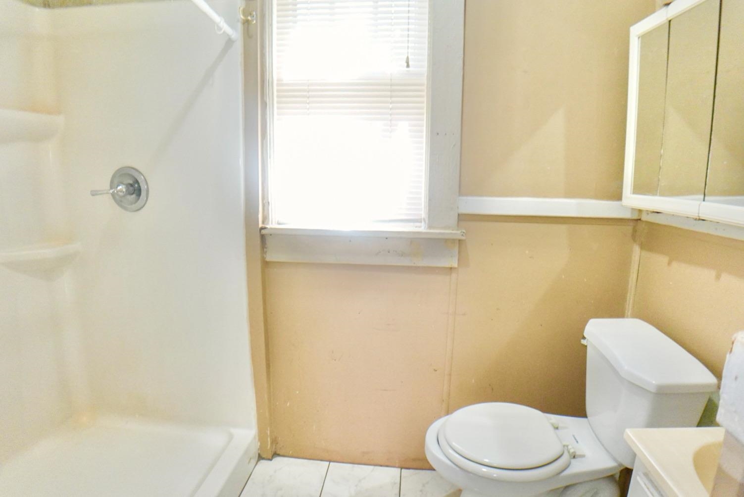778 Atlantic Street Memphis, TN 38112 - Photo 7 of 15 a white toilet sitting next to a bath tub
