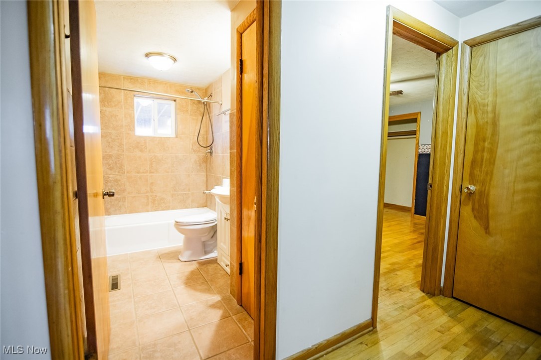 91 Mike Street Washington, WV 26181 - Photo 17 of 42 Bathroom with vanity, shower / tub combination, and light tile patterned flooring