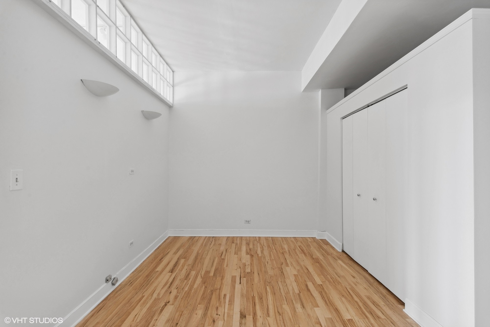 411 South Sangamon Street, Unit 2D Chicago, IL 60607 - Photo 14 of 18 a view of a room with wooden floor and white walls