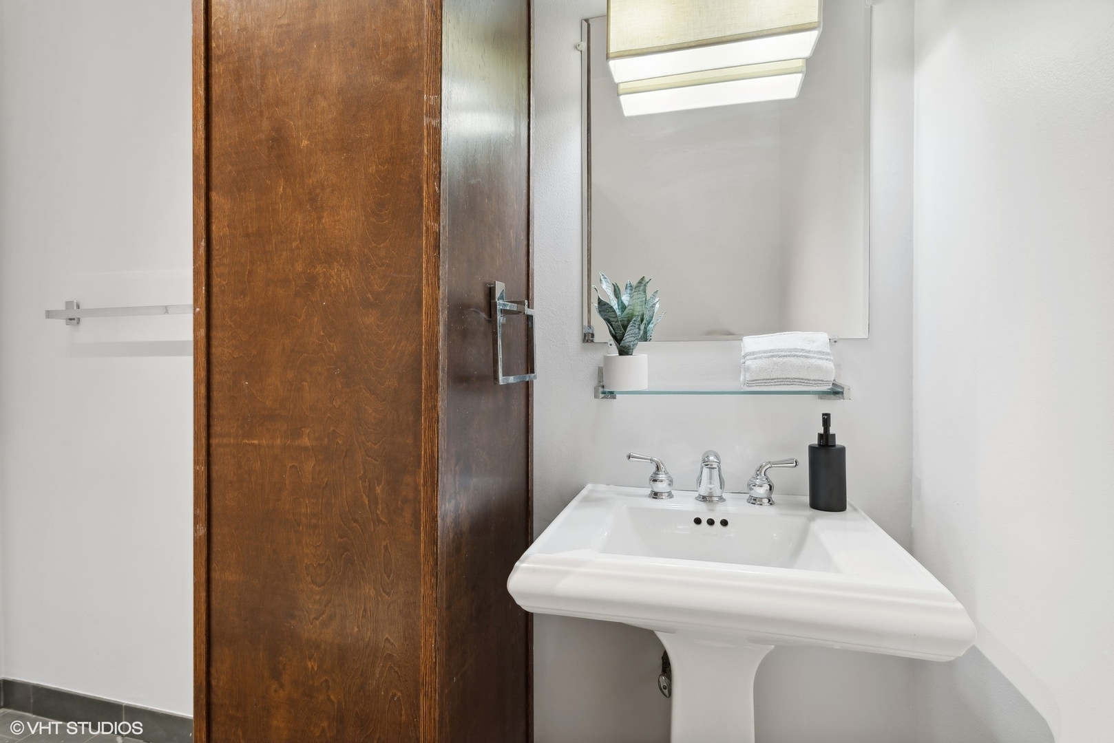 411 South Sangamon Street, Unit 2D Chicago, IL 60607 - Photo 17 of 18 a bathroom with a sink and a mirror