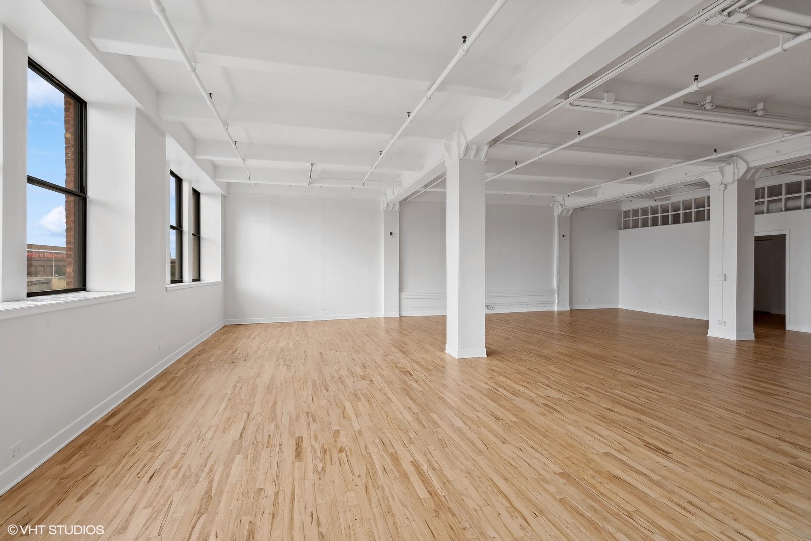 411 South Sangamon Street, Unit 2D Chicago, IL 60607 - Photo 4 of 18 a view of an empty room with wooden floor