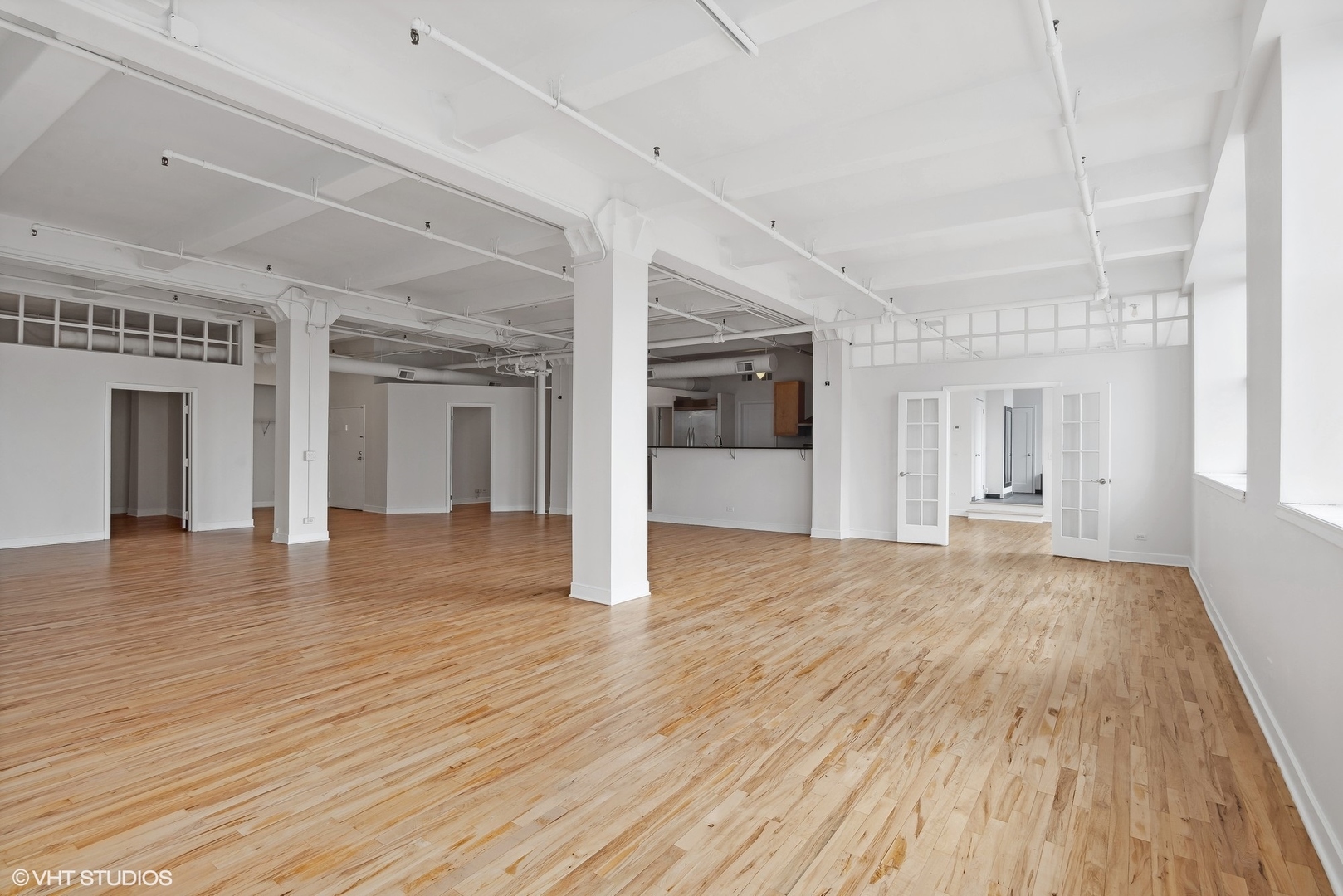 411 South Sangamon Street, Unit 2D Chicago, IL 60607 - Photo 5 of 18 a view of an empty room with wooden floor and a window