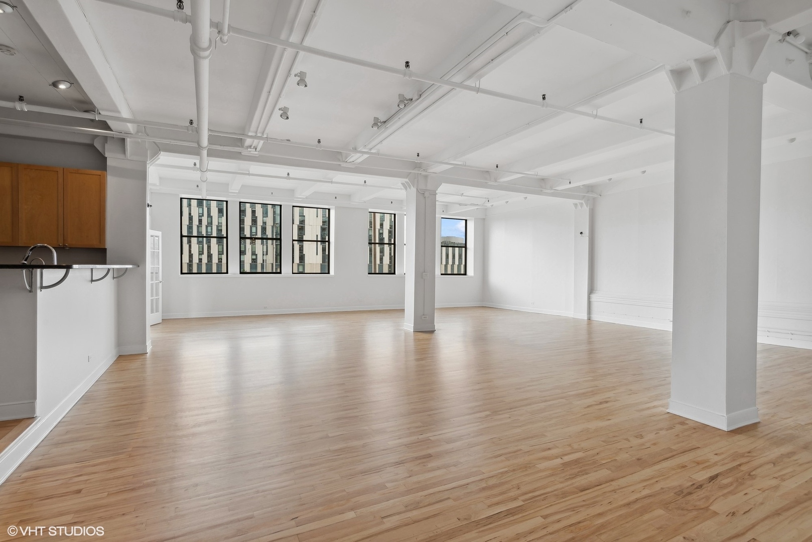 411 South Sangamon Street, Unit 2D Chicago, IL 60607 - Photo 6 of 18 a view of an empty room with wooden floor and a window
