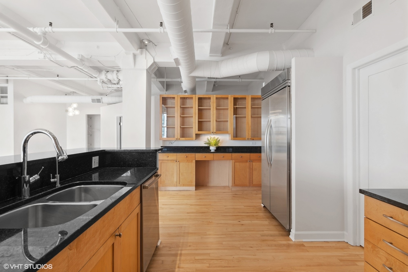 411 South Sangamon Street, Unit 2D Chicago, IL 60607 - Photo 8 of 18 a kitchen with granite countertop a sink and cabinets