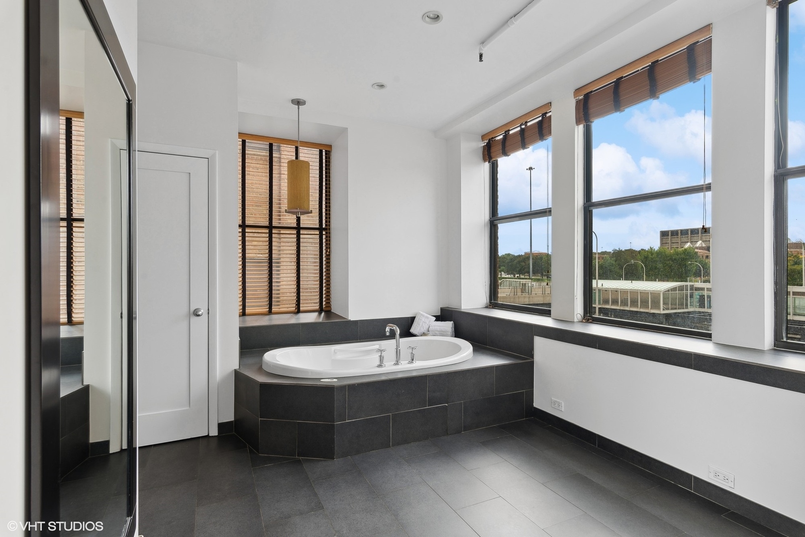 411 South Sangamon Street, Unit 2D Chicago, IL 60607 - Photo 10 of 18 a bathroom with a tub a sink and a window