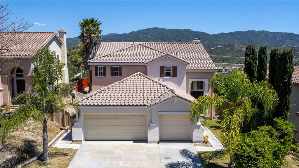 a front view of a house with a garden and plants