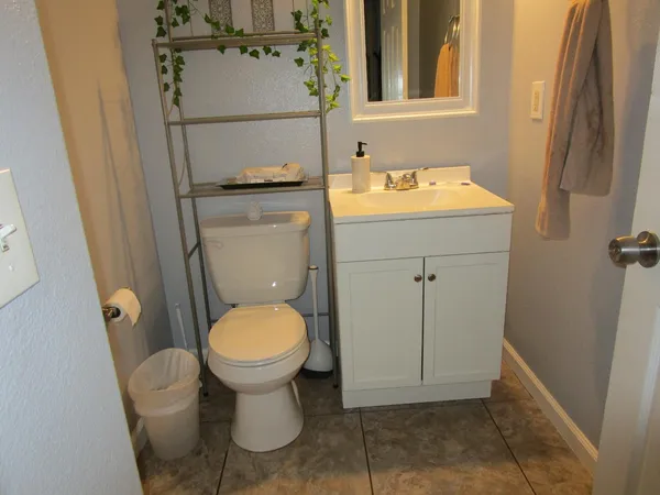 a bathroom with a toilet sink and mirror