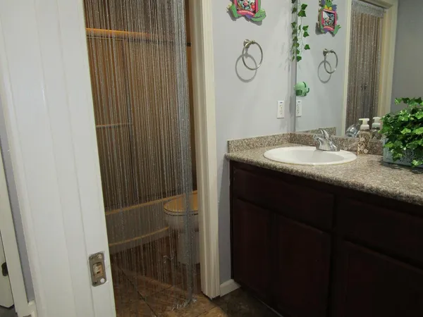 a bathroom with a granite countertop sink and a mirror