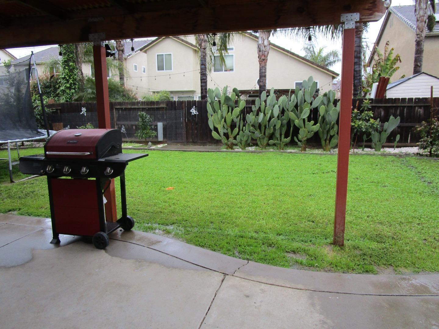 413 Hydrangea Court Merced, CA 95341 - Photo 15 of 16 a view of a chair and table in backyard of the house