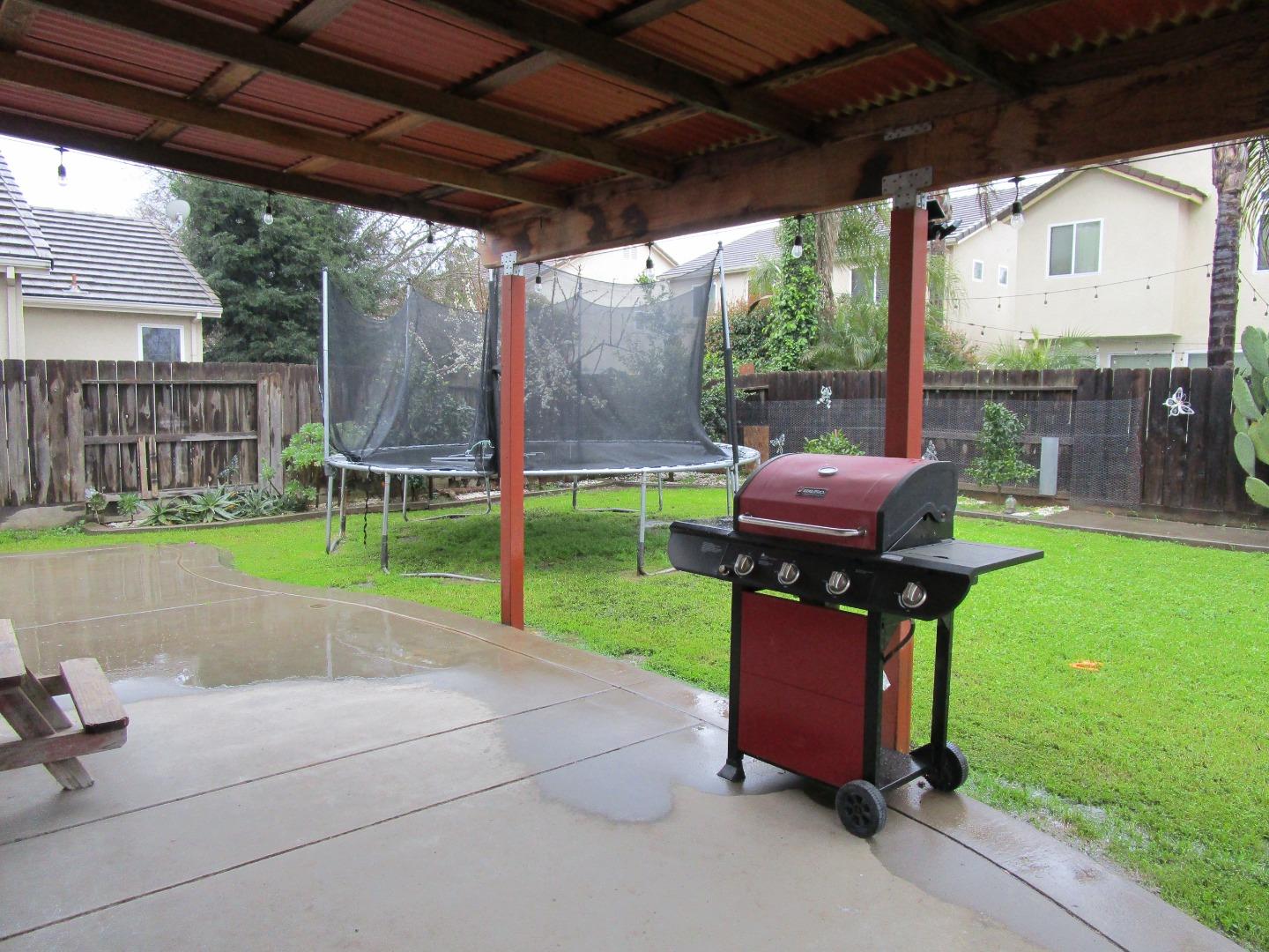 413 Hydrangea Court Merced, CA 95341 - Photo 16 of 16 a house view with a sitting space and garden view