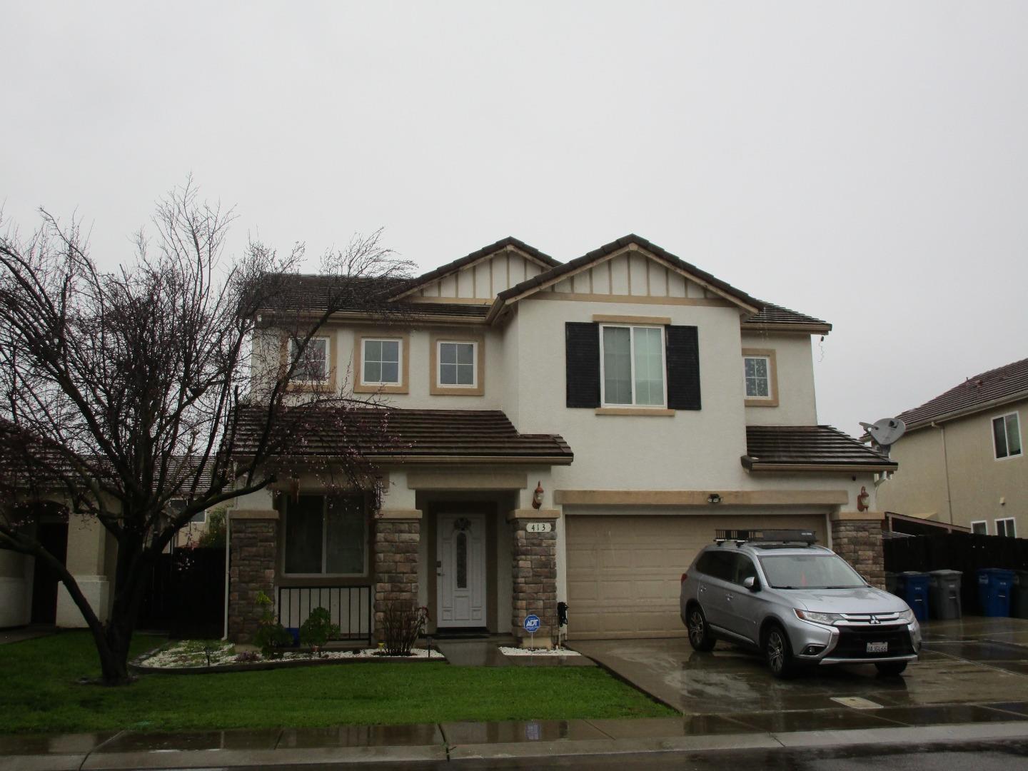 413 Hydrangea Court Merced, CA 95341 - Photo 2 of 16 a car parked in front of a white house