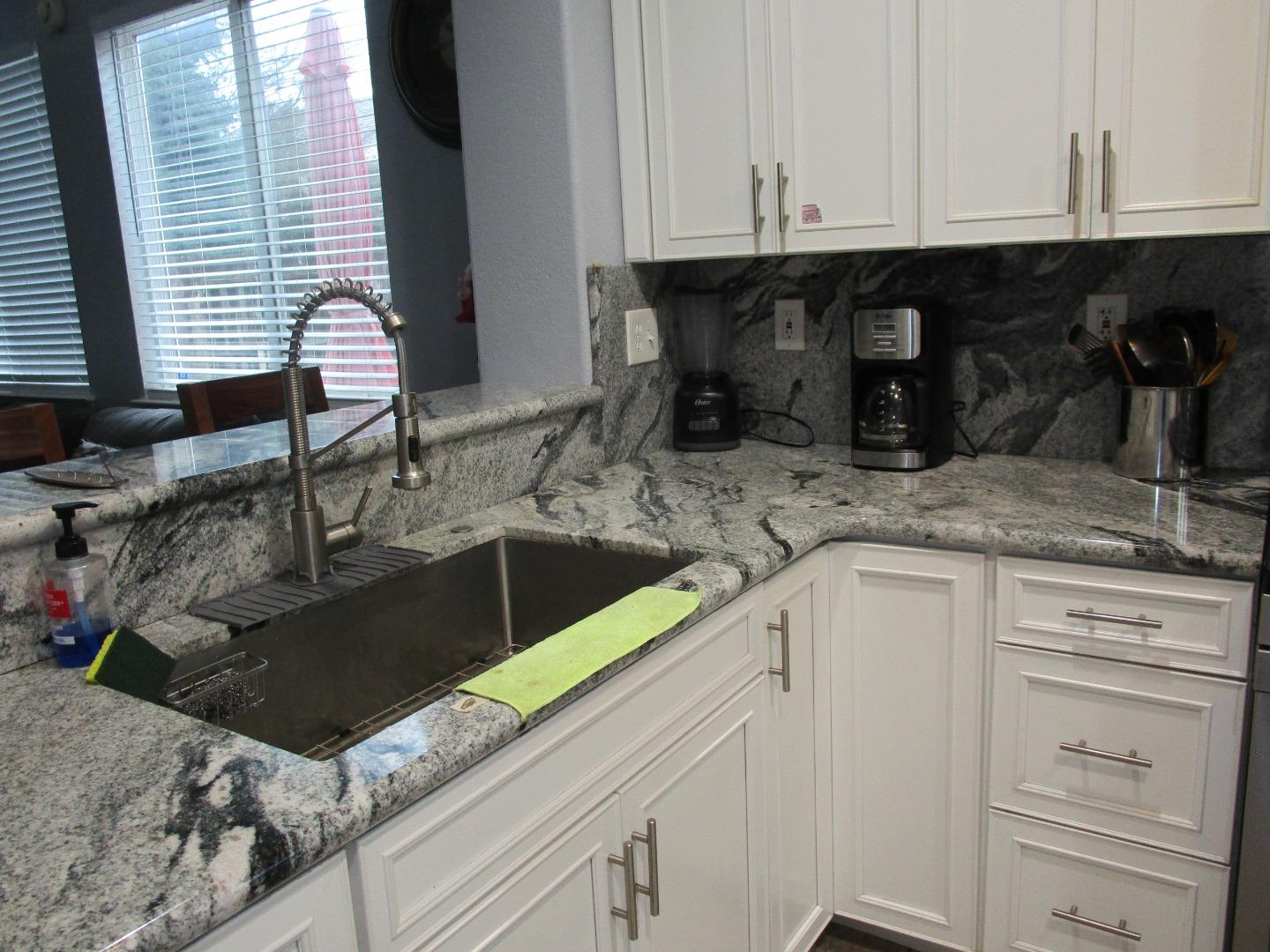 413 Hydrangea Court Merced, CA 95341 - Photo 4 of 16 a kitchen with a sink and cabinets