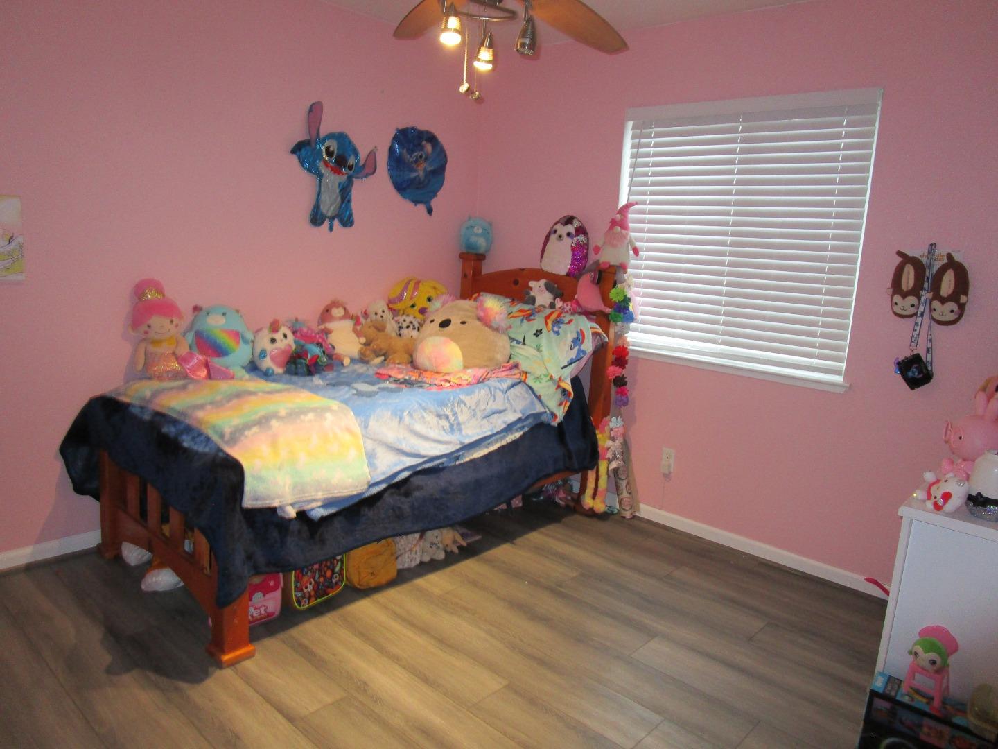 413 Hydrangea Court Merced, CA 95341 - Photo 8 of 16 a bed room with a bed and a couch