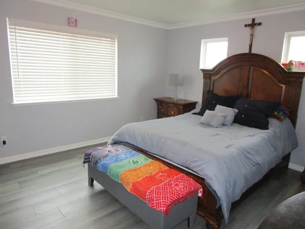 a bedroom with a bed a window and dresser