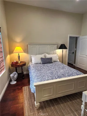 a bedroom with a bed and dresser