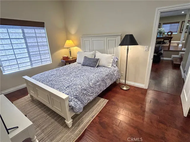 a living room with a bed furniture and a large window