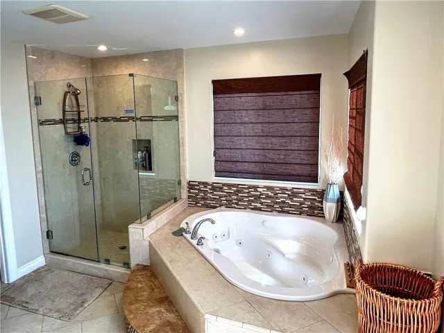 a bathroom with a bathtub and a shower