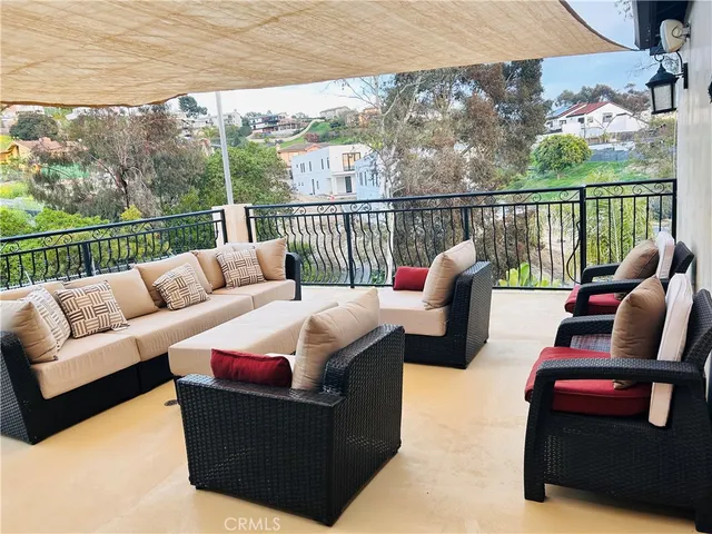 a balcony with furniture and wooden floor