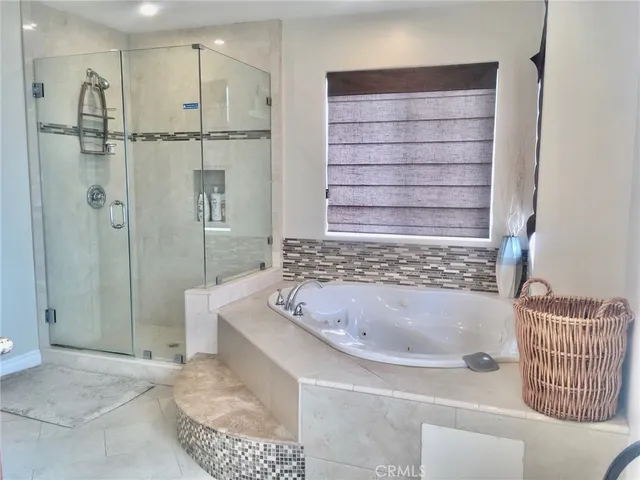 a bathroom with a bathtub and a shower