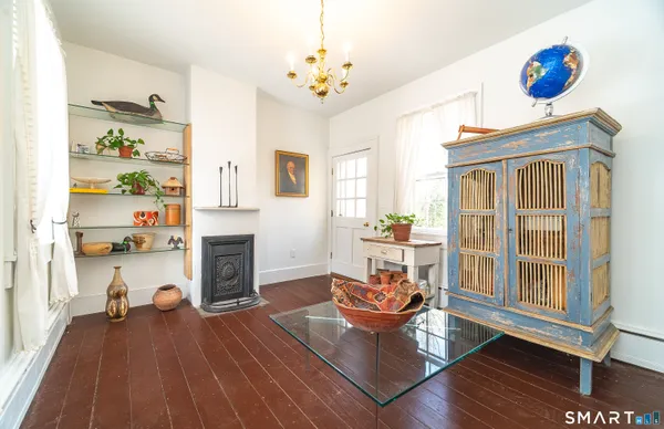 a living room with fireplace furniture and a wooden floor