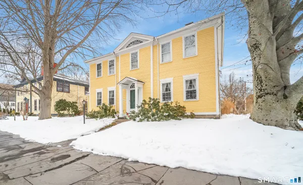 a front view of a building with a yard