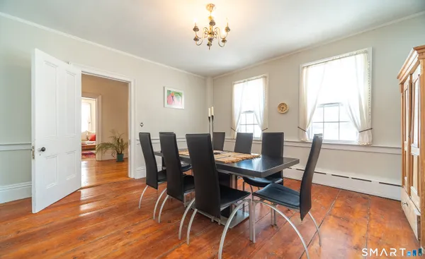 a view of a dining room with furniture window and wooden floor