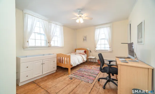 a bedroom with furniture and a window