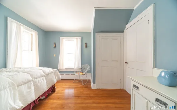 a spacious bedroom with a bed and a window