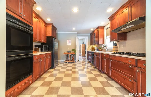 a kitchen with stainless steel appliances granite countertop a refrigerator and a sink