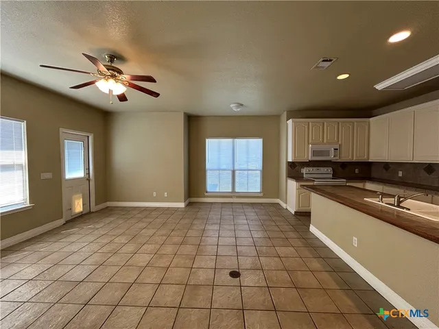 a view of a kitchen with a sink and a window