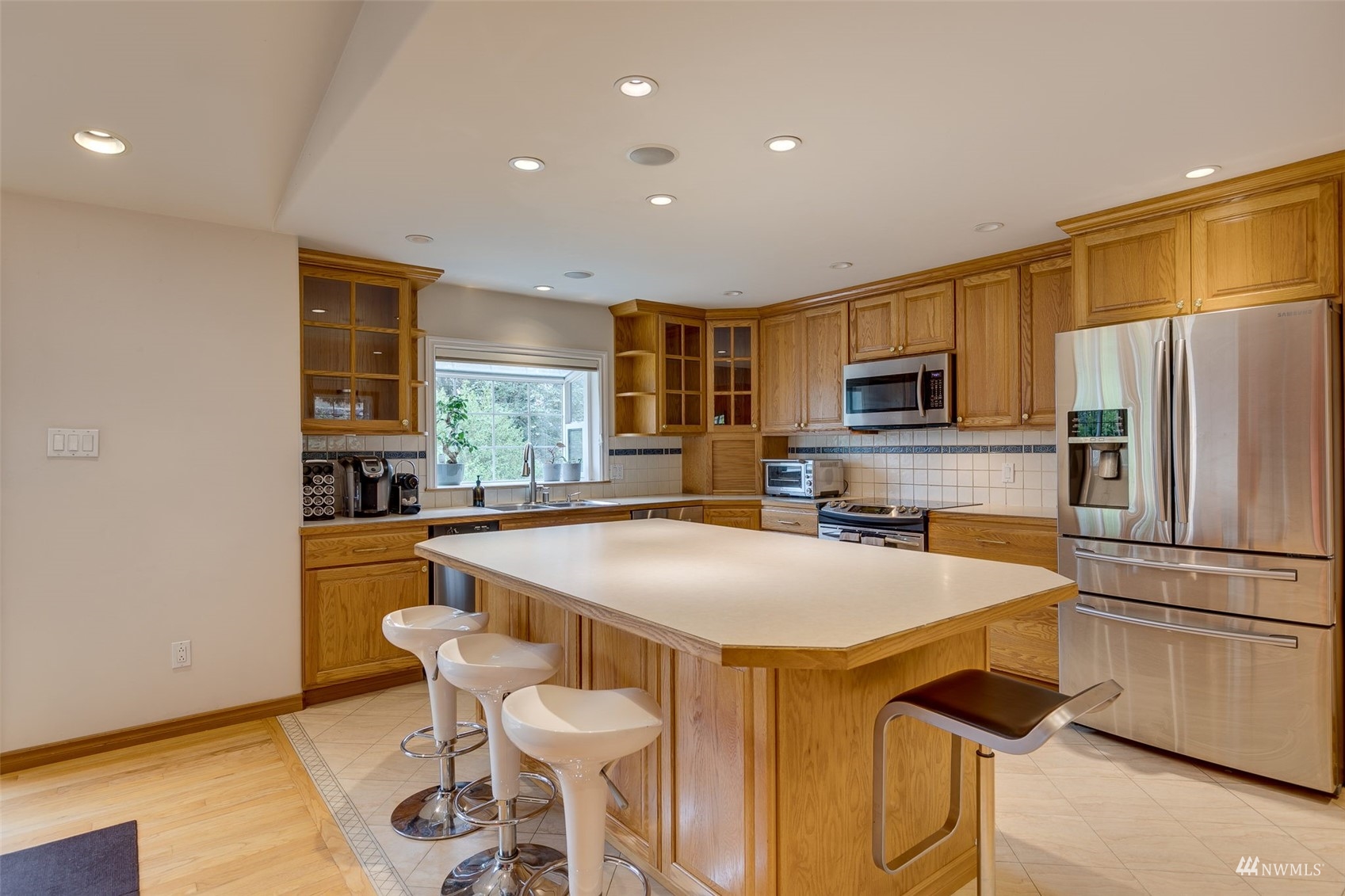 22417 4th Avenue Southeast Bothell, WA 98021 - Photo 9 of 27 a kitchen with a table chairs refrigerator and microwave